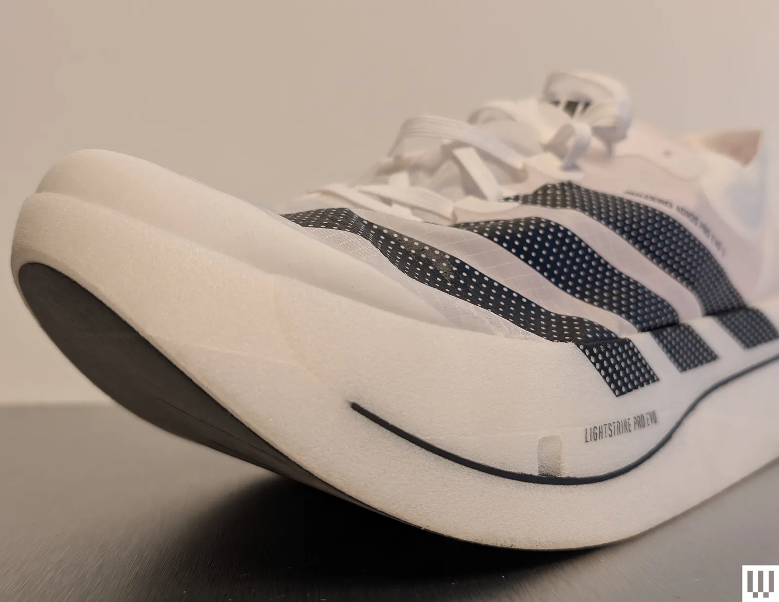 Side profile of the adizero adios pro evo 3 showing its distinctive rocker geometry